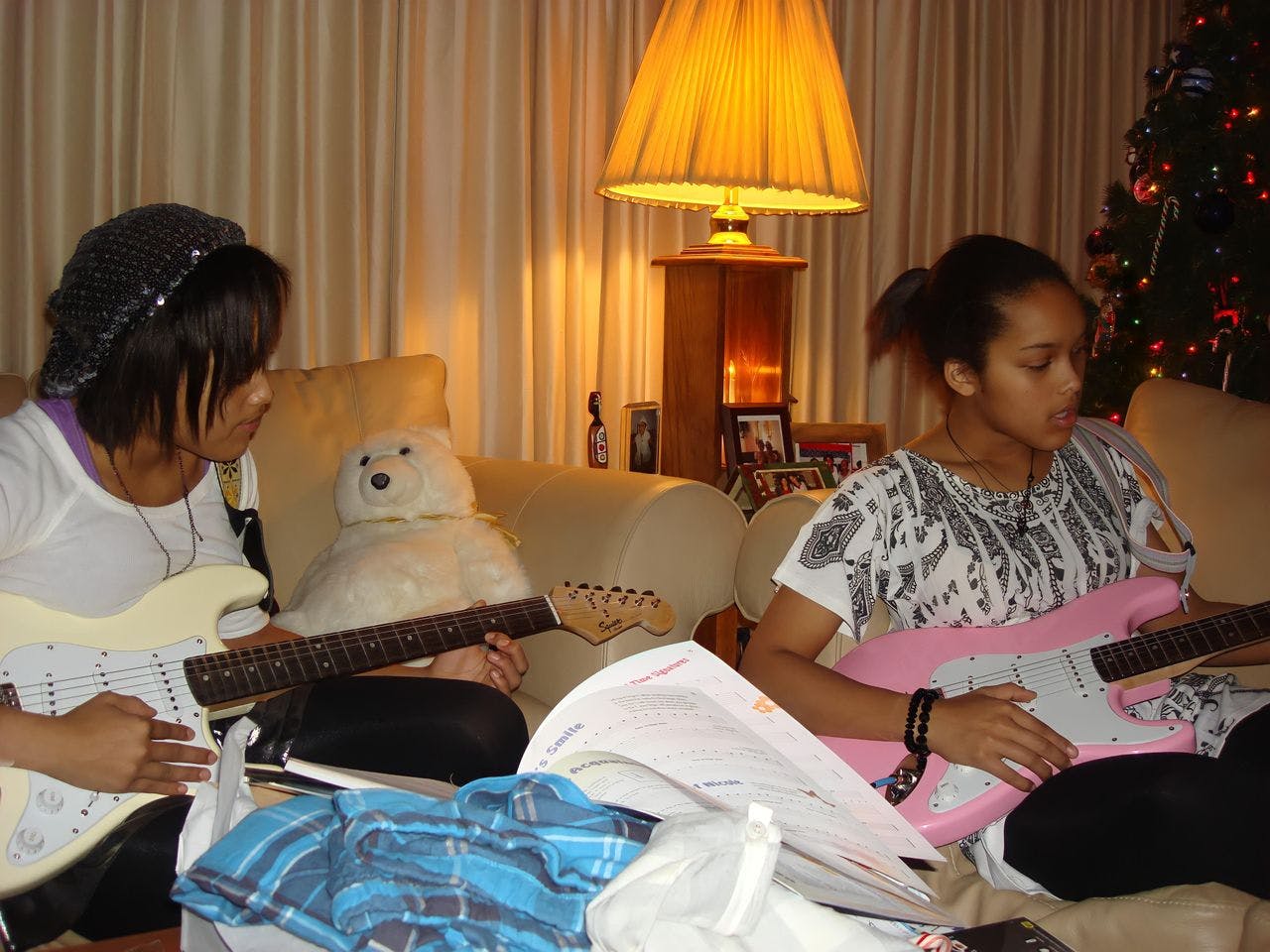 Young RaeCola learning the ropes on the guitar